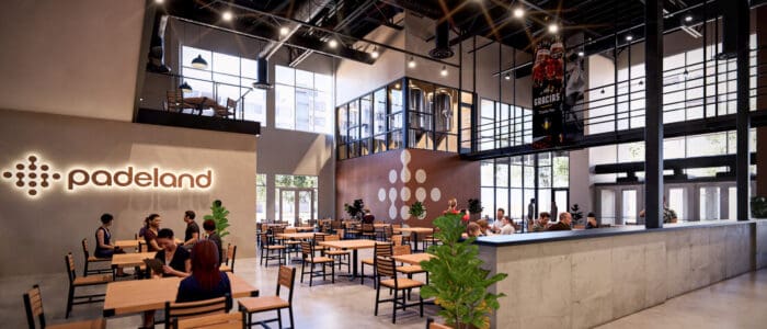 Rendering of spacious dining hall with Padeland logo and groups seated.